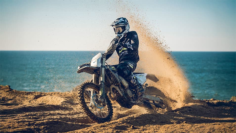 Triumph TF 250-E riding shot on the mud by the coast